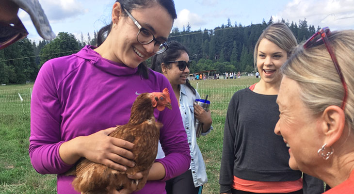 RDN program student holding chicken at farm visit