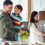 Photo of young family preparing meal