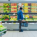 Man shopping for fruits and vegetables at a grocery store