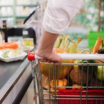 Photo of person pushing grocery cart in store