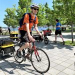 Photo bike messenger carrying food with Seattle waterfront pictured in the background